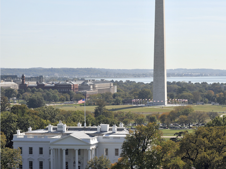 This image features the White House in the foreground with the Washington Monument in the background on a clear day.